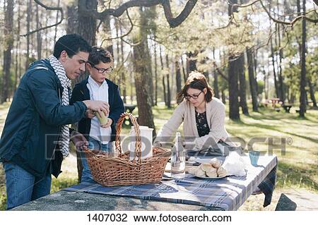 Family preparing for breakfast in forest View Large Photo Image Stock Image - Family preparing for breakfast in forest. Fotosearch