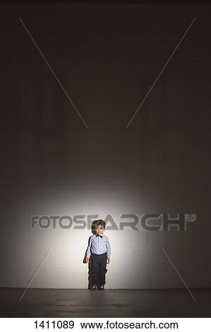 Full length of boy standing against wall View Large Photo Image Stock Photo - Full length of boy standing against wall. Fotosearch