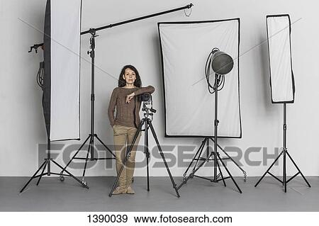 Full length of confident mature female photographer in photo studio View Large Photo Image Stock Photo - Full length of confident mature female photographer in photo studio. Fotosearch