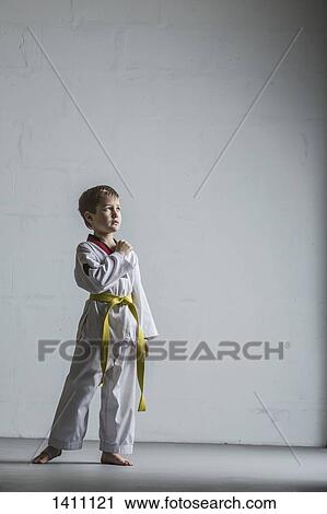 Full length of karate boy standing against white wall View Large Photo Image Stock Image - Full length of karate boy standing against white wall. Fotosearch