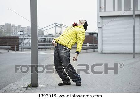 Full length of mature man stretching backward on sidewalk View Large Photo Image Stock Photograph - Full length of mature man stretching backward on sidewalk. Fotosearch