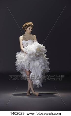 Full length of young bride in wedding dress standing over colored background View Large Photo Image Stock Photo - Full length of young bride in wedding dress standing over colored background. Fotosearch