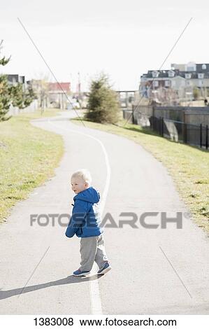 Full length side view of baby boy walking on road View Large Photo Image Stock Photo - Full length side view of baby boy walking on road. Fotosearch