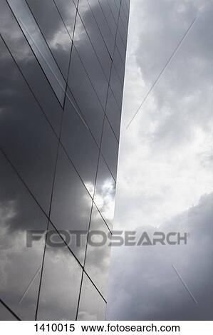 Glass building against cloudy sky View Large Photo Image Stock Photography - Glass building against cloudy sky. Fotosearch