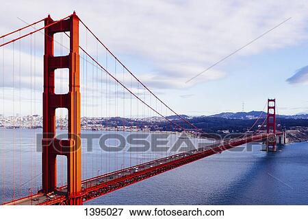 Golden Gate Bridge over San Francisco Bay against cloudy sky View Large Photo Image Stock Photo - Golden Gate Bridge over San Francisco Bay against cloudy sky. Fotosearch