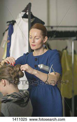 Hairdresser making model's hair in studio View Large Photo Image Stock Photography - Hairdresser making model's hair in studio. Fotosearch