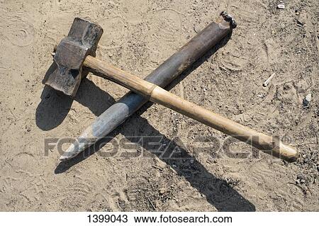 Hammer and chisel on sand View Large Photo Image Stock Image - Hammer and chisel on sand. Fotosearch