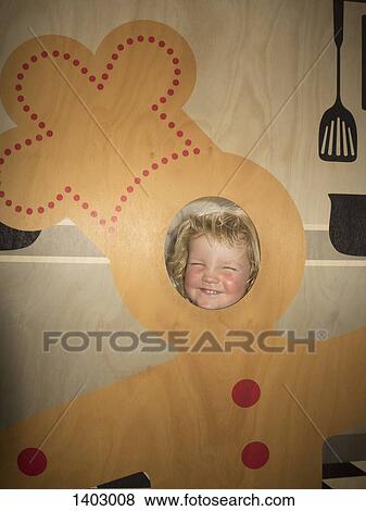 Stock Photo - Happy cute boy in gingerbread man costume at home. Fotosearch