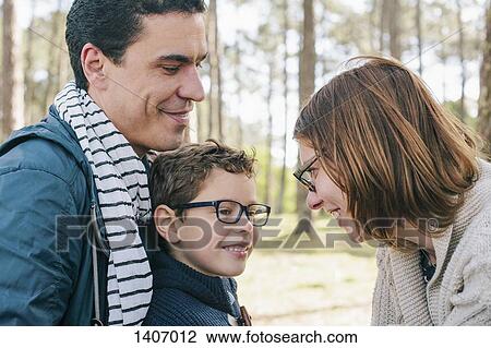 Stock Image - Happy family in forest. Fotosearch