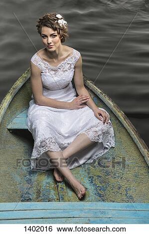 High angle portrait of young bride sitting in boat on lake View Large Photo Image Stock Photograph - High angle portrait of young bride sitting in boat on lake. Fotosearch