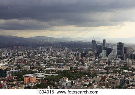 Stock Photography - High angle view of cityscape against cloudy sky. Fotosearch