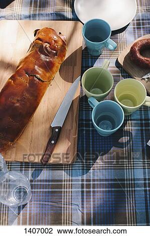 High angle view of empty mugs with bread loaf on table outdoors View Large Photo Image Stock Image - High angle view of empty mugs with bread loaf on table outdoors. Fotosearch