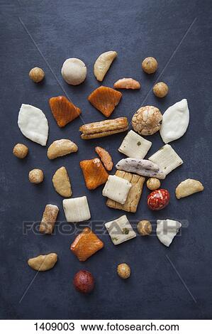 Stock Image - High angle view of Japanese rice crackers on table. Fotosearch