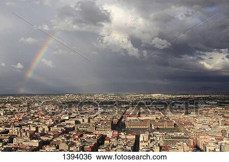 Stock Photograph - High angle view of Metropolitan Cathedral and National Palace amidst cityscape. Fotosearch