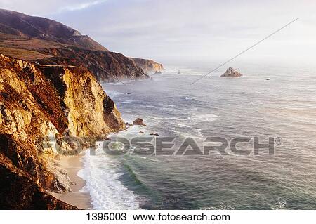 Stock Image - High angle view of rocky cliff by sea. Fotosearch