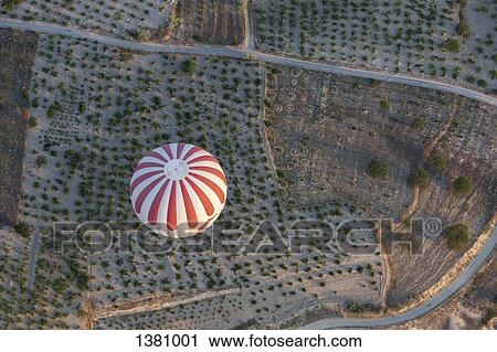 High angle view of striped hot air balloon flying over agricultural landscape View Large Photo Image Stock Image - High angle view of striped hot air balloon flying over agricultural landscape. Fotosearch