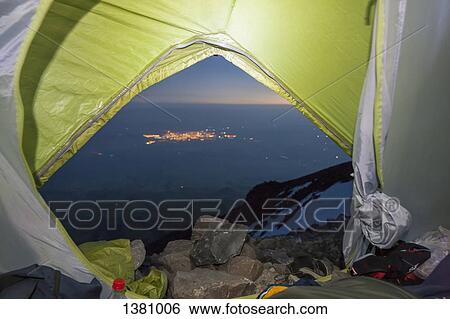 Stock Photograph - Landscape seen through tent on mountain at dusk. Fotosearch