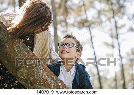 Loving mother and son looking at each other in forest View Large Photo Image Stock Photo - Loving mother and son looking at each other in forest. Fotosearch