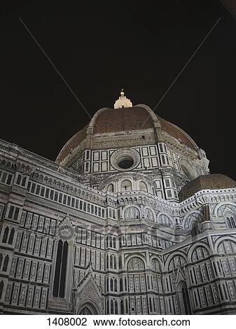 Stock Image - Low angle view of Duomo Santa Maria Del Fiore against sky at night. Fotosearch