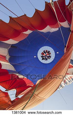 Low angle view of hot air balloon against sky View Large Photo Image Picture - Low angle view of hot air balloon against sky. Fotosearch