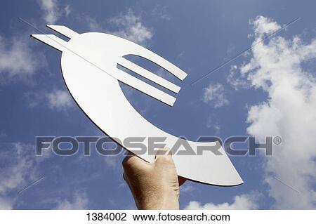 Low angle view of man's hand holding euro symbol against sky View Large Photo Image Stock Image - Low angle view of man's hand holding euro symbol against sky. Fotosearch
