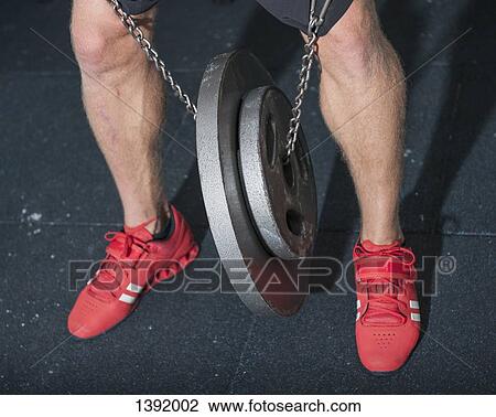 Low section of man with weights in gym View Large Photo Image Stock Image - Low section of man with weights in gym. Fotosearch