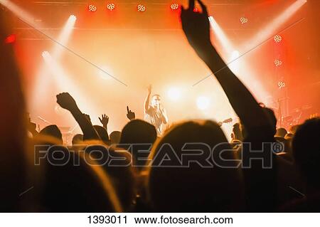 Stock Image - Male singer performing in front of audience. Fotosearch