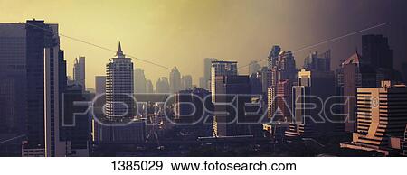 Stock Photo - "Modern buildings at Bangkok against sky during sunset, Thailand". Fotosearch