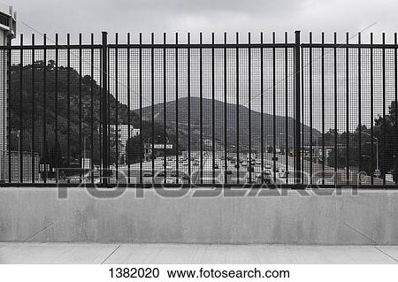 Mountain and street seen through fence against sky View Large Photo Image Stock Image - Mountain and street seen through fence against sky. Fotosearch