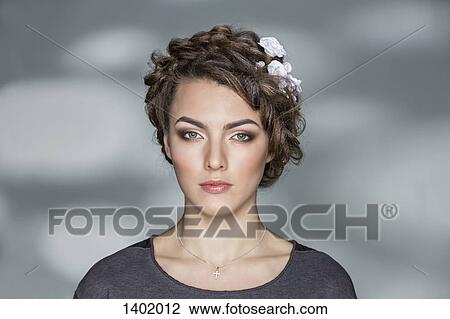 Portrait of beautiful young woman against wall View Large Photo Image Stock Image - Portrait of beautiful young woman against wall. Fotosearch