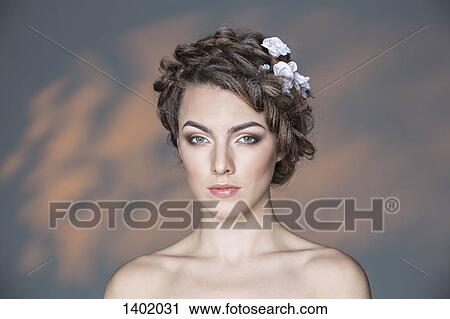 Portrait of beautiful young woman against wall View Large Photo Image Stock Image - Portrait of beautiful young woman against wall. Fotosearch