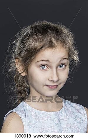 Portrait of confident girl over gray background View Large Photo Image Stock Photo - Portrait of confident girl over gray background. Fotosearch