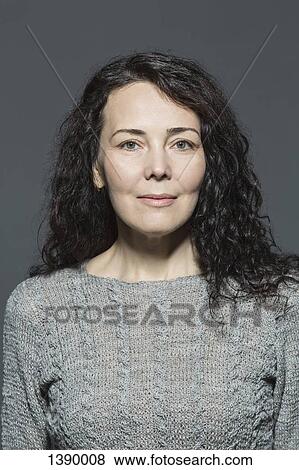 Portrait of confident mature woman over gray background View Large Photo Image Stock Photo - Portrait of confident mature woman over gray background. Fotosearch