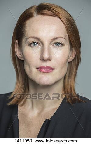 Portrait of confident mature woman against gray background View Large Photo Image Stock Image - Portrait of confident mature woman against gray background. Fotosearch
