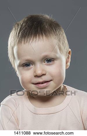 Portrait of cute boy against gray background View Large Photo Image Stock Photo - Portrait of cute boy against gray background. Fotosearch