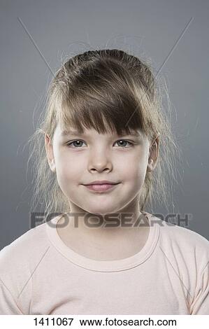 Portrait of cute girl against gray background View Large Photo Image Stock Photo - Portrait of cute girl against gray background. Fotosearch