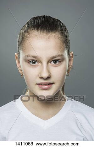 Stock Photo - Portrait of girl against gray background. Fotosearch