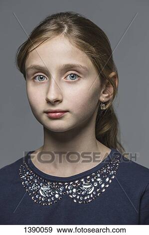 Stock Photo - Portrait of girl over gray background. Fotosearch