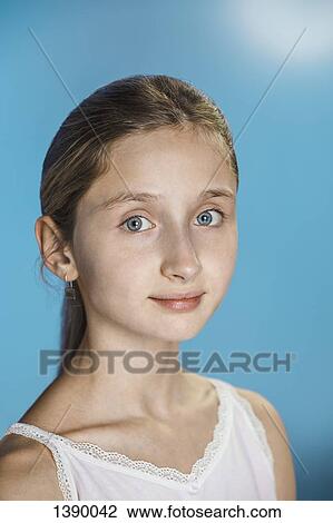 Portrait of happy girl over blue background View Large Photo Image Stock Image - Portrait of happy girl over blue background. Fotosearch