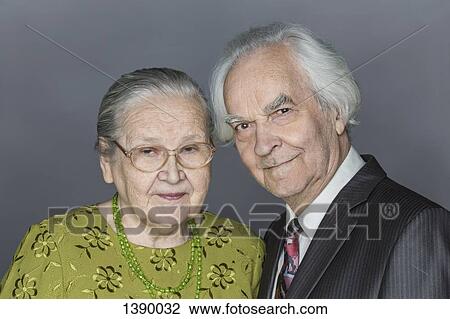 Portrait of happy senior couple over gray background View Large Photo Image Stock Image - Portrait of happy senior couple over gray background. Fotosearch