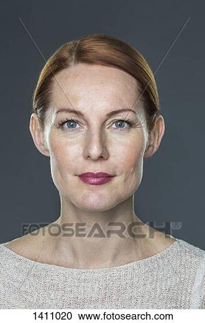 Portrait of mature woman against gray background View Large Photo Image Stock Image - Portrait of mature woman against gray background. Fotosearch