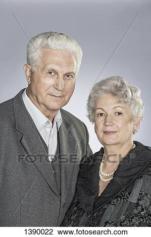Portrait of senior couple against gray background View Large Photo Image Stock Image - Portrait of senior couple against gray background. Fotosearch