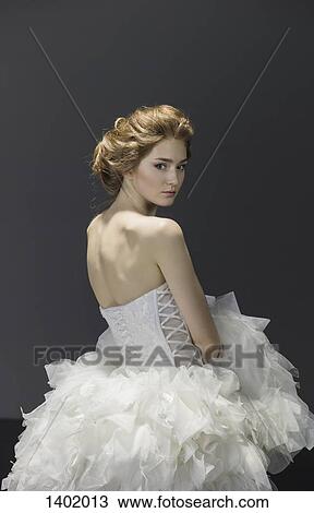 Portrait of young bride in wedding dress over colored background View Large Photo Image Stock Image - Portrait of young bride in wedding dress over colored background. Fotosearch