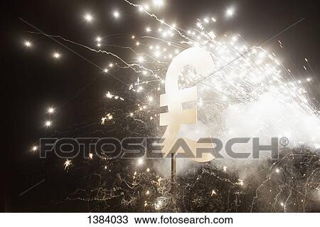 Stock Image - Pound symbol with fireworks at night. Fotosearch