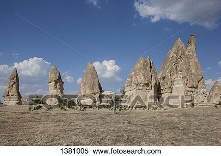 Stock Photography - Rock formations on arid landscape against blue sky. Fotosearch