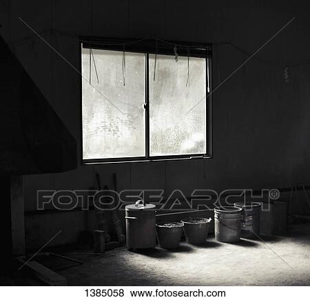 Row of containers by window in abandoned room View Large Photo Image Stock Photo - Row of containers by window in abandoned room. Fotosearch