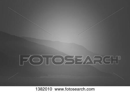Scenic view of mountains by sea against sky View Large Photo Image Stock Image - Scenic view of mountains by sea against sky. Fotosearch