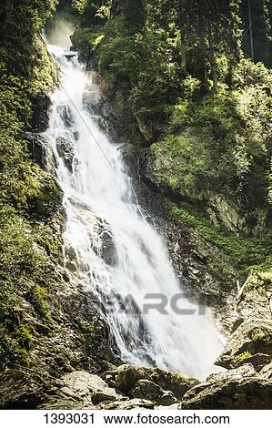 Scenic view of waterfall in forest View Large Photo Image Stock Image - Scenic view of waterfall in forest. Fotosearch
