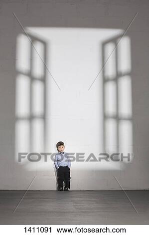 Shadow of open window falling on boy standing against white wall at home View Large Photo Image Stock Image - Shadow of open window falling on boy standing against white wall at home. Fotosearch