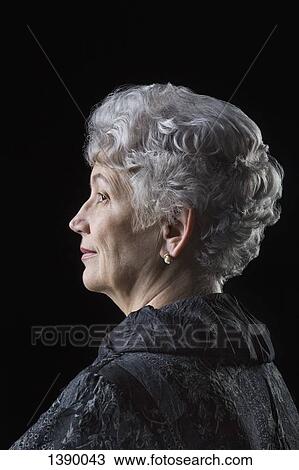 Side view of senior woman over black background View Large Photo Image Stock Image - Side view of senior woman over black background. Fotosearch